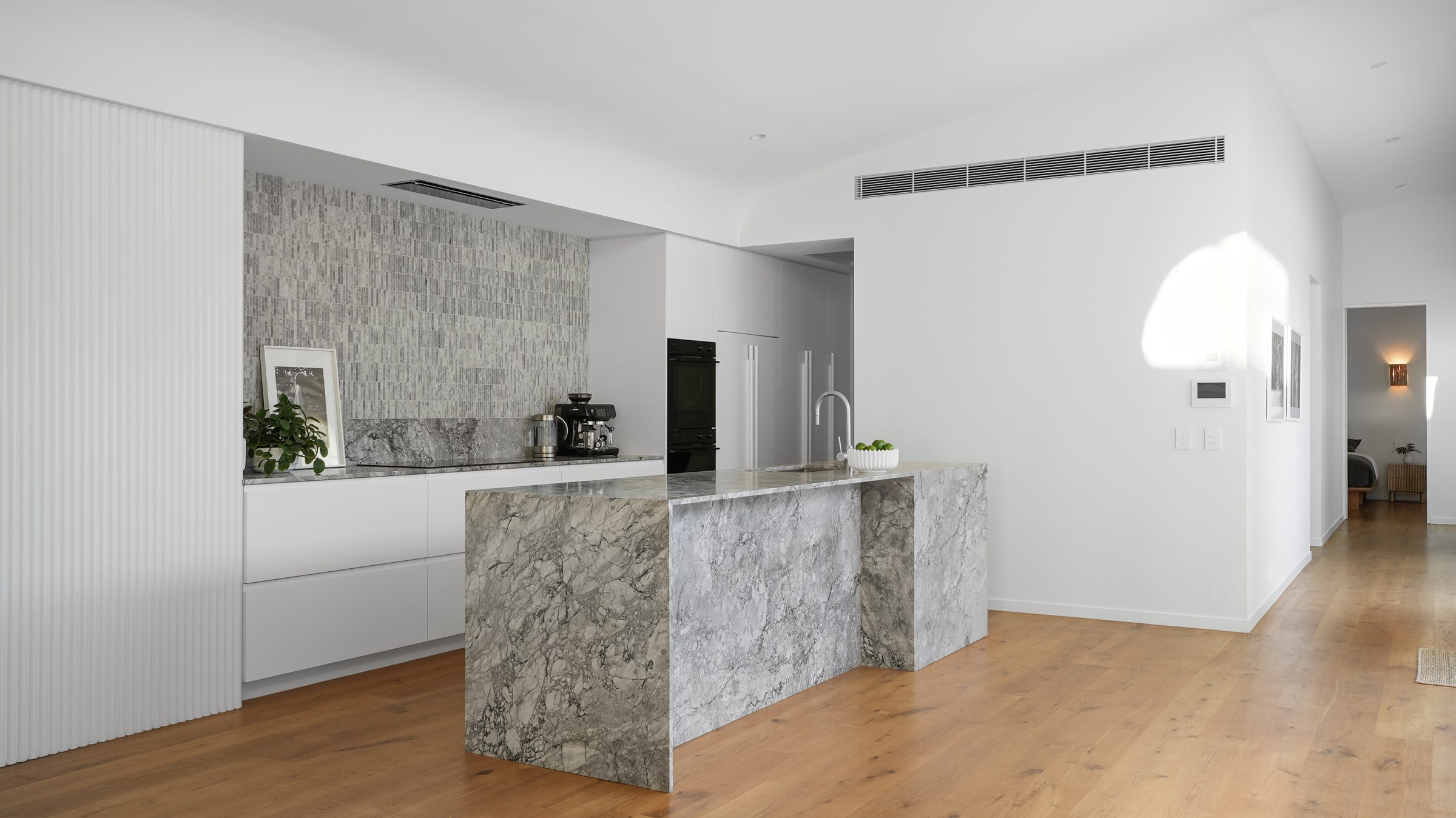 Kitchen from the hallway, marble island in profile